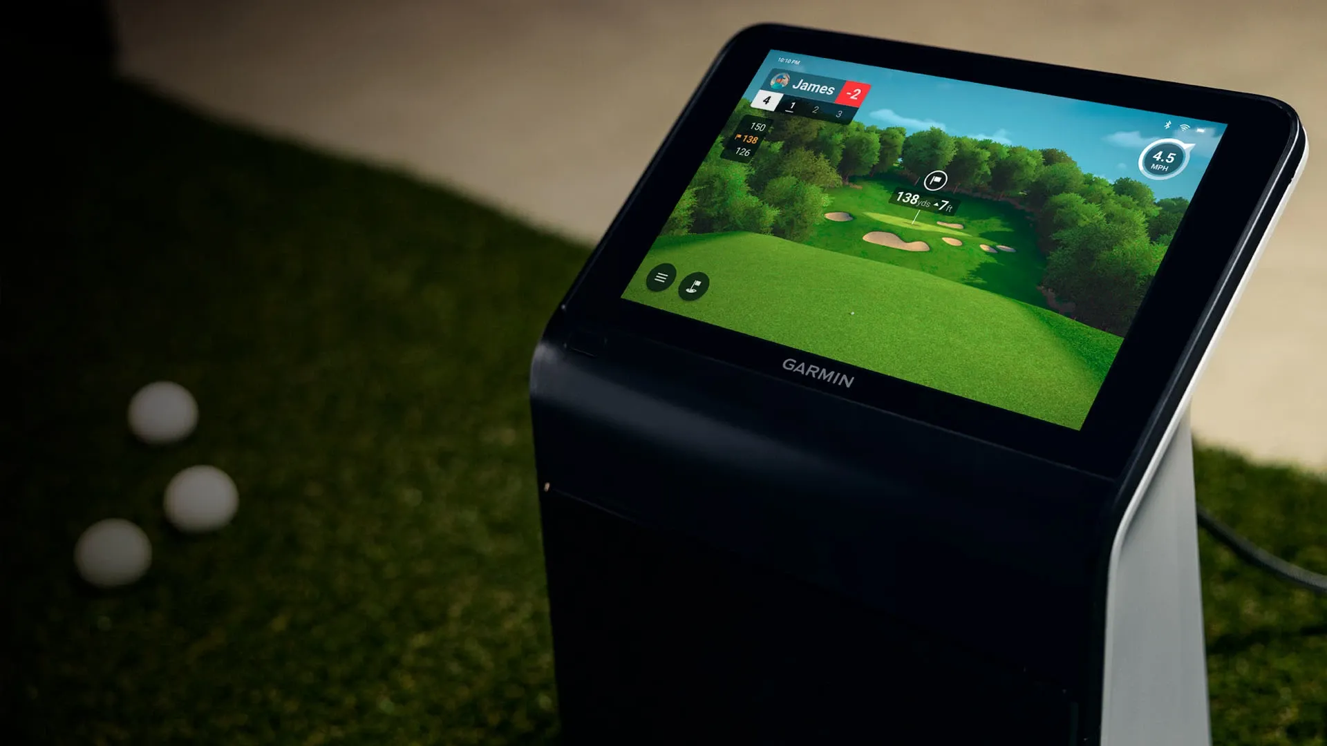 Close-up of the Garmin R50 screen showing carry distance data outdoors